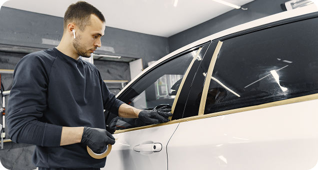 Technician working on a car window